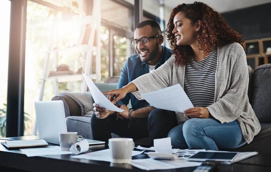 A couple review their bills after consolidating their debt.