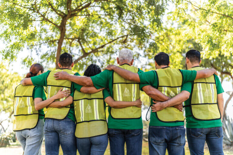 A group of volunteers wearing vests with the Columbia Credit Union logo on them