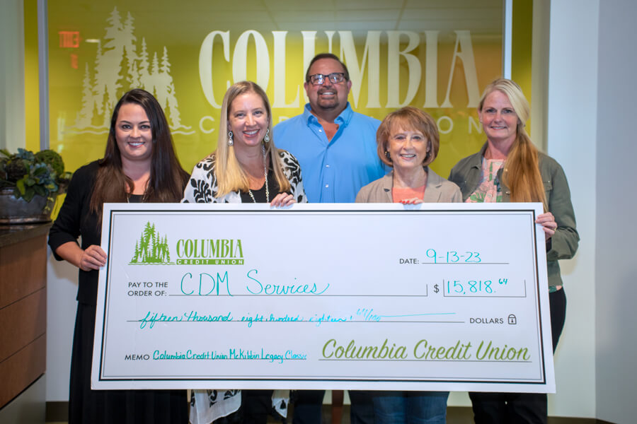 CDM Caregiving Services receives their donation from the Columbia Credit Union McKibbin Legacy Classic.